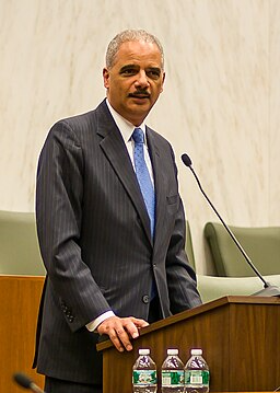 Eric Holder speaking at a podium