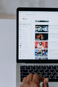 Person browsing Youtube on laptop