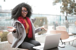 Cheerful woman speaking to a laptop