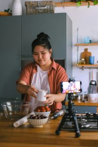 Woman recording herself while cooking