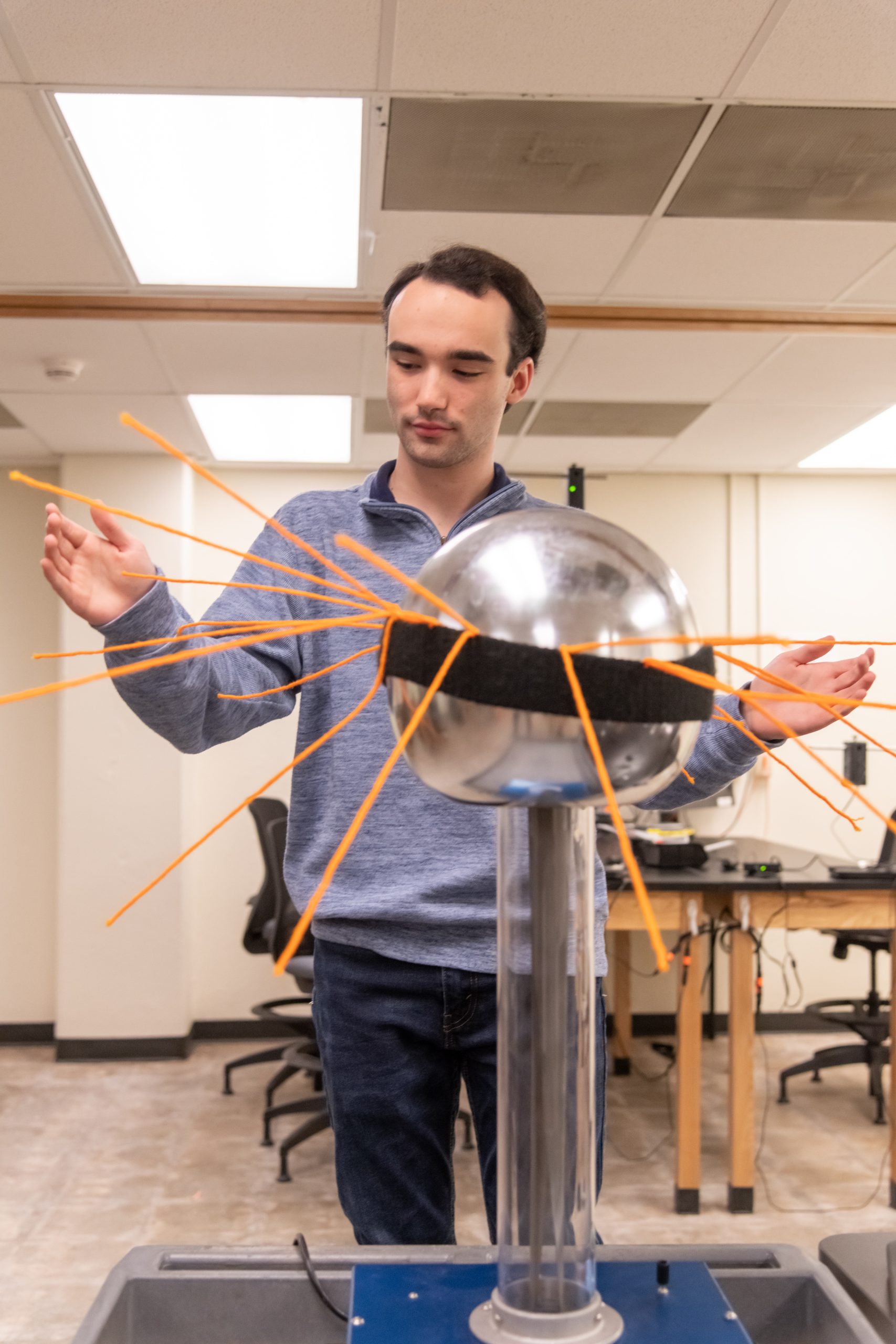 A student using a model as a visual aid.