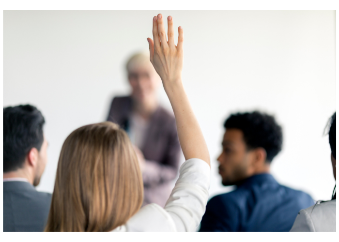 Student raising hand asking question.