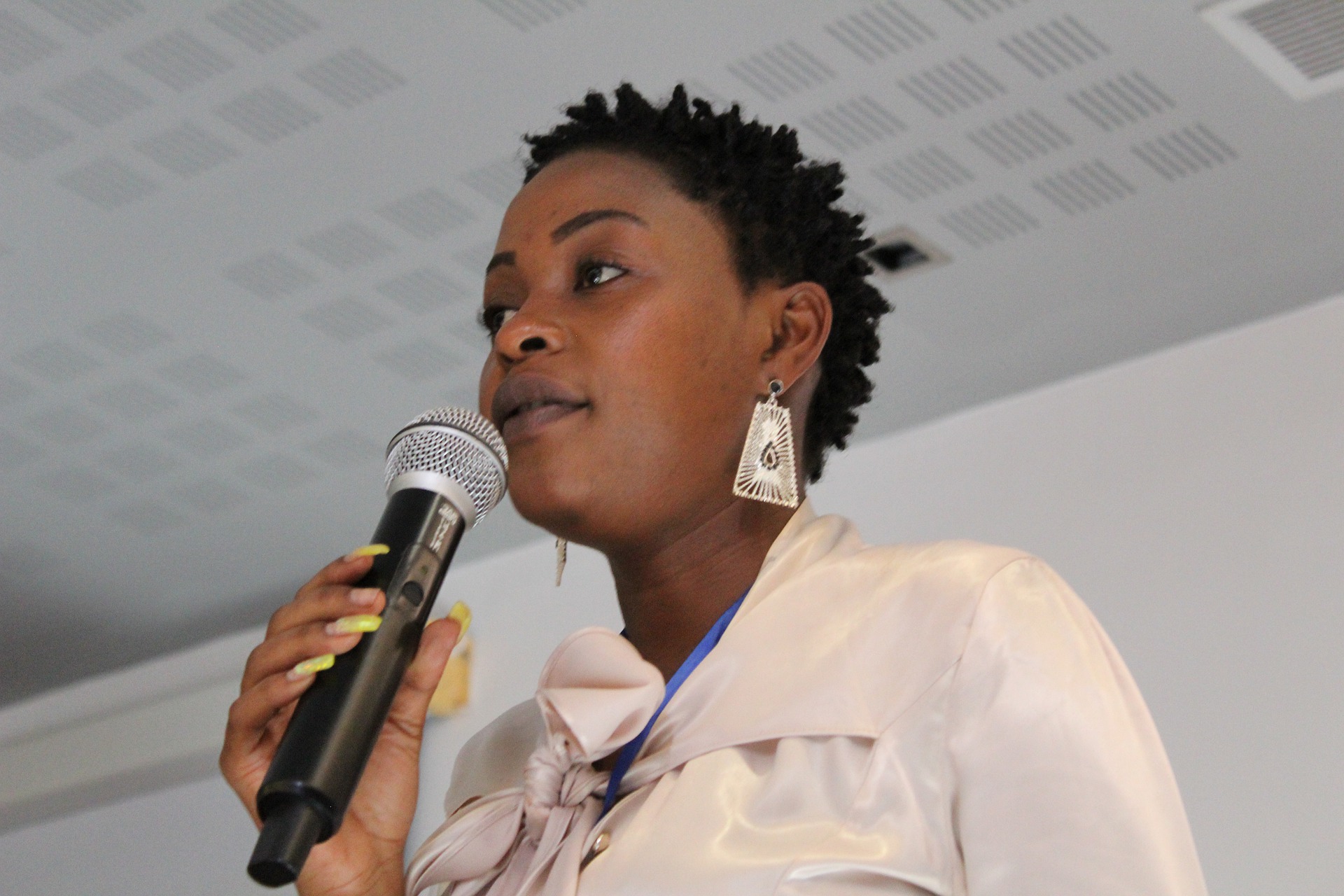 A woman is speaking into the microphone